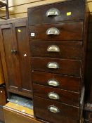 A vintage seven-drawer compact cabinet together with an oak slate top pot cupboard