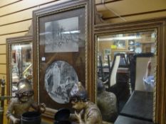 A vintage light oak overmantel mirror with black & white prints to centre, hunting scene etc