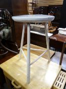 An antique painted white small cricket table