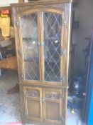 An Old Charm dark oak standing corner cupboard, lead glazed upper & cupboard base