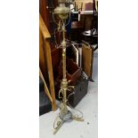 A brass & metal adjustable columned oil lamp converted to electric
