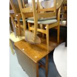 A 1960s lightwood drop leaf dining table together with four butterfly beechwood cushion seat