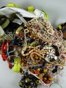 A large bag of various costume jewellery, necklaces etc