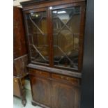 A reproduction mahogany astragal glazed top cupboard bookcase