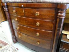Late Victorian bow fronted flame mahogany chest of drawers, two short above three long with column
