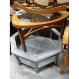 A G-Plan style teak circular glass top coffee table together with a painted grey octagonal glass top