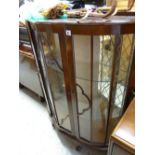 A vintage bow fronted mahogany effect display cabinet