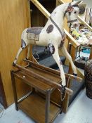 A vintage wooden child's rocking horse together with an oak tea trolley