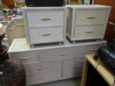 A modern white wicker chest of drawers, two bedside cabinets & a headboard