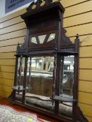 A vintage overmantel mirror with shelves