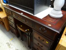 Modern reproduction dark wood kneehole desk with a wine & gold tooled leather top