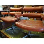 A pair of retro chrome & leatherette swivel chairs