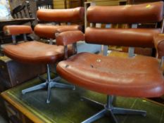 A pair of retro chrome & leatherette swivel chairs