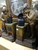 Two large continental pottery figures, boy & girl cooking on a range (possibly Dutch) with