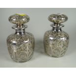 A pair of sterling silver overlaid decoration Art Nouveau-style bottles