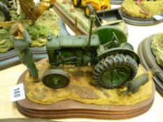 Country Artists model of a farmer scratching his head, with a green tractor, title to plaque 'Won'