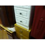 Pair of modern white narrow three drawer chests and another wood effect chest