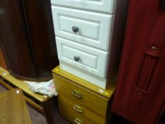 Pair of modern white narrow three drawer chests and another wood effect chest