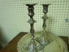 Pair of electroplate candlesticks and a three footed electroplate tray
