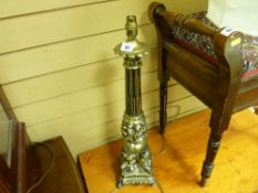 Metallic black and gilt cherub decorated table lamp with shade