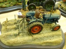 Country Artists model of a farmer in a blue tractor ploughing a field, sculptor Ayres