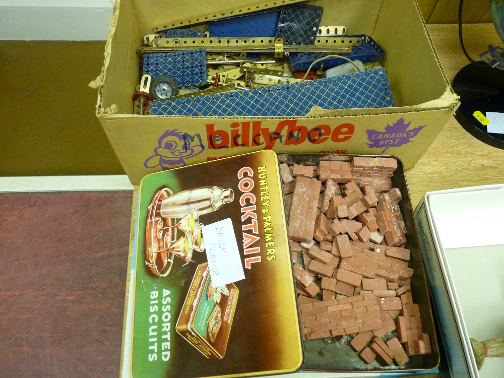 Box of Meccano construction material and a tin of clay type play bricks