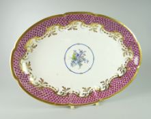 A SWANSEA PORCELAIN OVAL DISH of lobed form and decorated with purple scale border, foliate