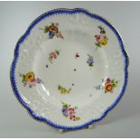 A NANTGARW PORCELAIN SOUP DISH having a lobed border with moulded scrolls, foliage & ribbons,