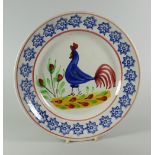 A LLANELLY COCKEREL PLATE typically decorated with blue sponged star decoration to the border, 24cms