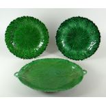 A SWANSEA POTTERY GREEN GLAZED LEAF-FORM DISH with twin loop handles, moulded vines and crimped rim,