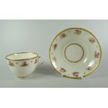 A SWANSEA GLASSY PORCELAIN CUP & SAUCER decorated with a series of open pink roses and gilding