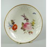 AN UNRECORDED NANTGARW PORCELAIN SAUCER DISH moulded with c-scrolls, flowers and wreaths and