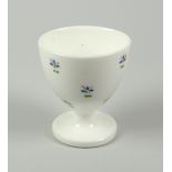 A SWANSEA PORCELAIN EGG CUP decorated with cornflower heads, Sidney Heath collection label to