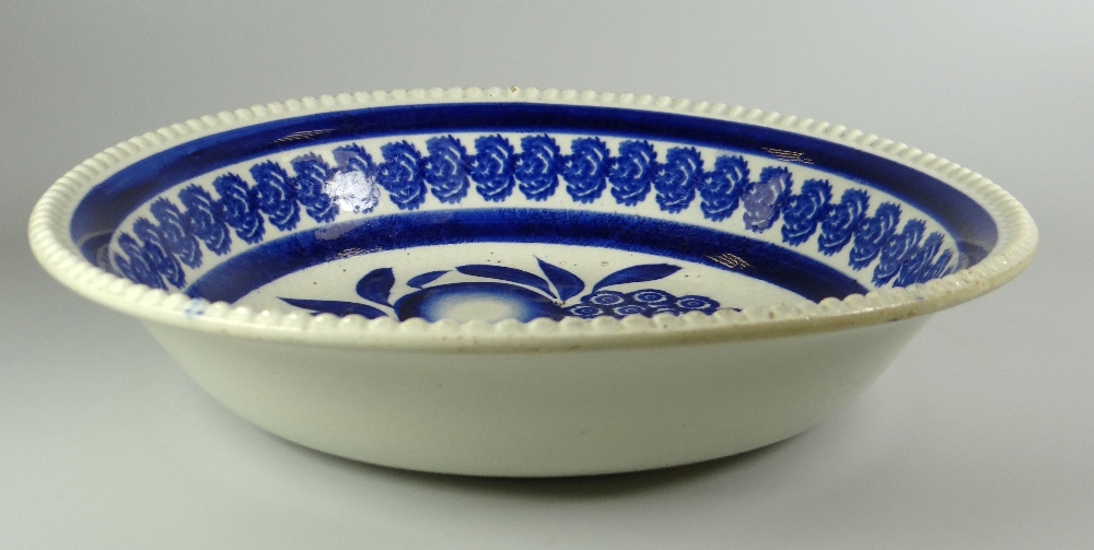 A LLANELLY POTTERY SPONGE WARE BOWL with moulded border and decorated in blue with centred fruit and - Image 2 of 2