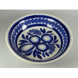 A LLANELLY POTTERY SPONGE WARE BOWL with moulded border and decorated in blue with centred fruit and