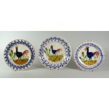 THREE SMALL LLANELLY COCKEREL PLATES with typical primitive decoration, 17cms and 16cms diam