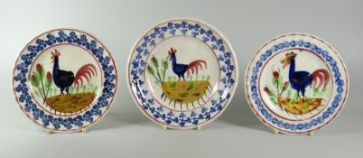 THREE SMALL LLANELLY COCKEREL PLATES with typical primitive decoration, 17cms and 16cms diam