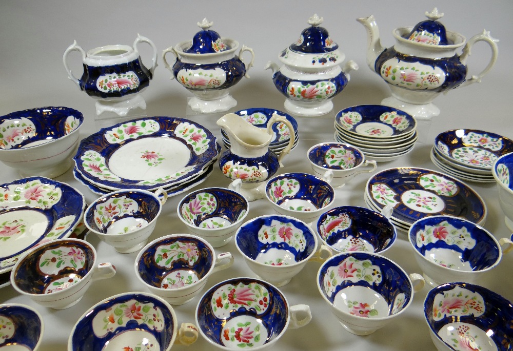 AN EXTENSIVE GAUDY WELSH TEAWARE SET in the Columbine pattern, 50+ pieces including teapots,