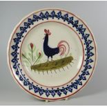 A LLANELLY POTTERY COCKEREL PLATE typically decorated with dark-blue sponged arrowhead motifs to the