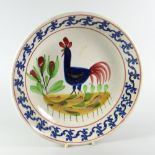 A LLANELLY POTTERY COCKEREL BOWL having a continuous blue foliate border, 26cms diam