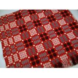 A GOOD WELSH BLANKET in a vivid red ground and with typical geometric black, white and flecked-