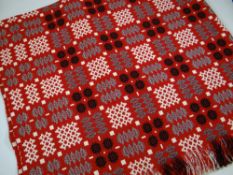 A GOOD WELSH BLANKET in a vivid red ground and with typical geometric black, white and flecked-