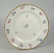 A NANTGARW PORCELAIN PLATE of lobed form, decorated with scattered roses and blue flowers within a