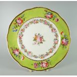 A NANTGARW PLATE with lobed border painted in lime-green with five floral sprays, decorated with