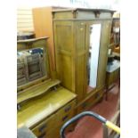 Four piece Arts & Crafts style bedroom suite comprising bedstead and irons, wardrobe, dressing table