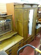 Four piece Arts & Crafts style bedroom suite comprising bedstead and irons, wardrobe, dressing table