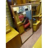 Large bevelled edge mirror with wooden frame and floral decoration