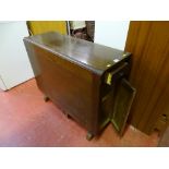 Polished wood drop leaf table with centre drawer and two shelf cupboard