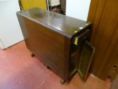 Polished wood drop leaf table with centre drawer and two shelf cupboard