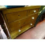 Pine chest of two short over two long drawers with white knobs (two missing)